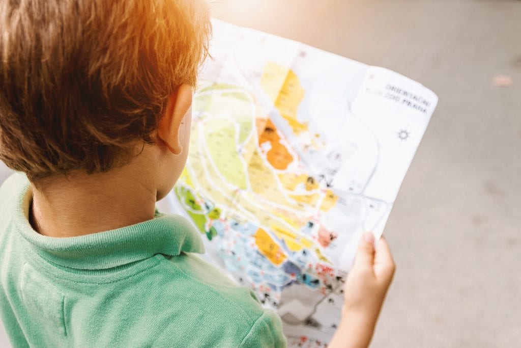 child with map for road trip
